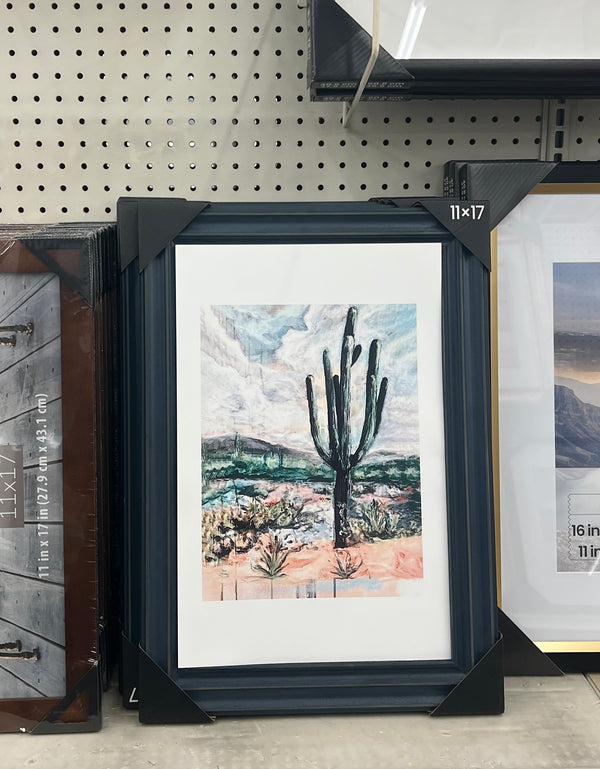 Framed artwork of a cactus in a store setting